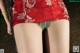 A close up of a woman wearing a red and green skirt.