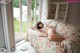 A woman laying on a couch in a room.